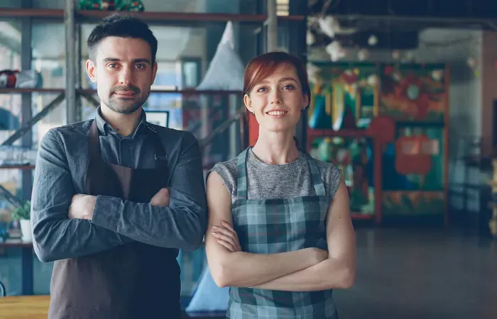 Two small business owners standing in their shop, showing local pros you can book through Local Service Central